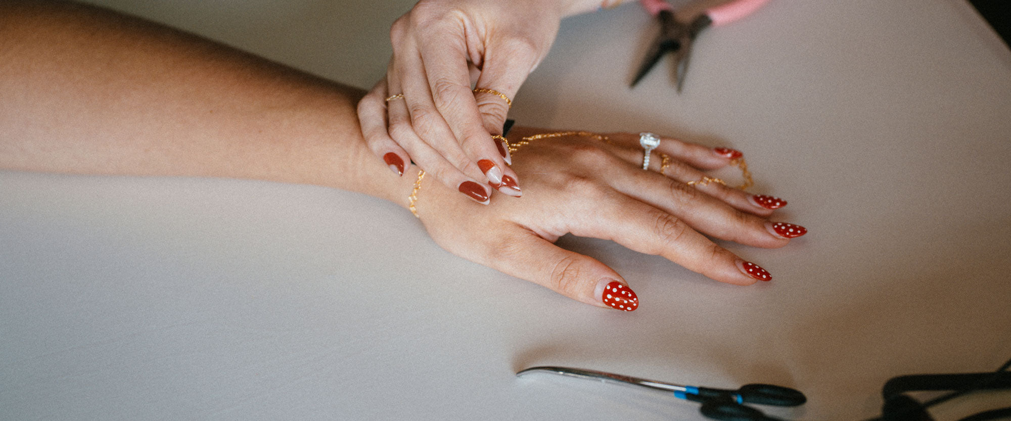 Permanent gold bracelet being fitted during a Pearl & Palm permanent. jewelry experience
